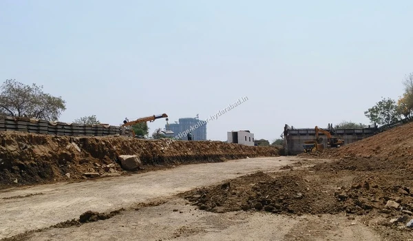 Documented on March 03 , 2026, heavy machinery including cranes and excavators are actively engaged in deep ground leveling and structural foundation work for Prestige Kollur Hyderabad, located near the Nehru Outer Ring Road.