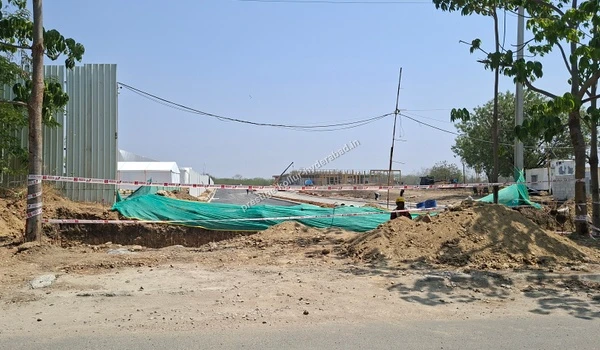Safety barricades and warning tape placed around an active excavation area at the Prestige Kollur development in Kollur, Hyderabad