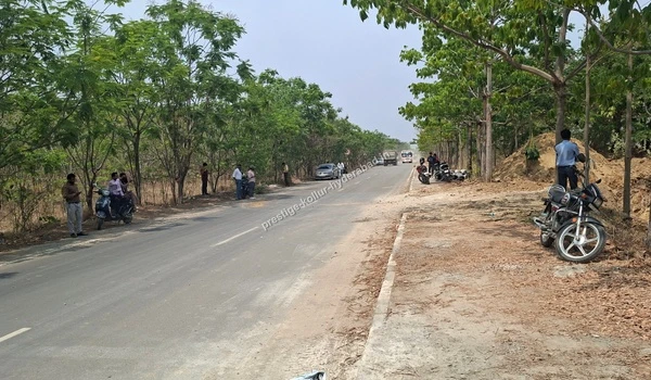 A wide scenic approach avenue lined with trees leading towards the Prestige Kollur development in Kollur, Hyderabad