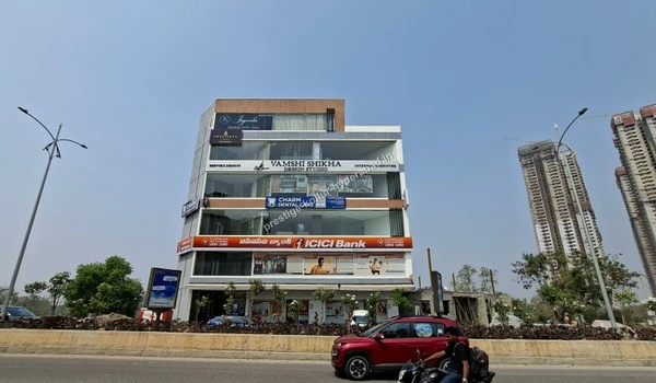Wide angle view of the building housing Charm Dental Care, providing accessible healthcare services near Prestige Kollur in Hyderabad