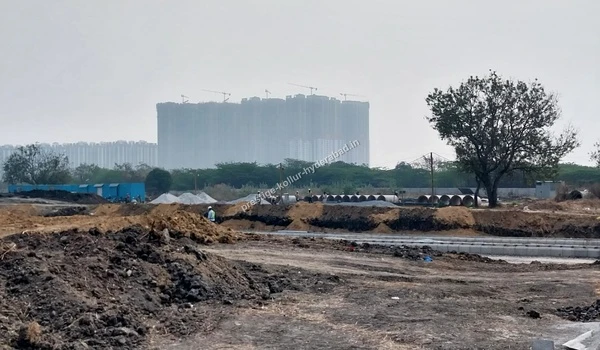 Construction progress showing high-rise towers at the Prestige Kollur site
