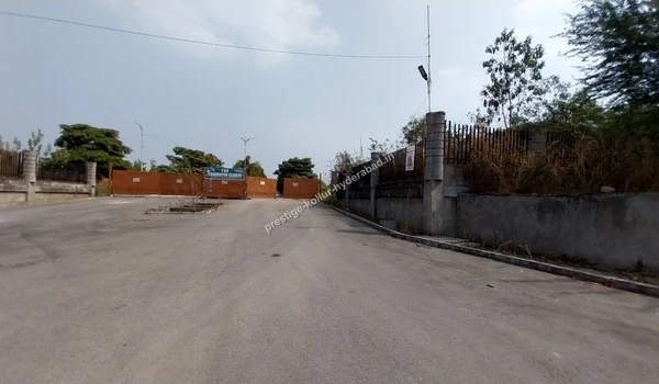 Secured perimeter fencing and entrance road at Prestige Kollur